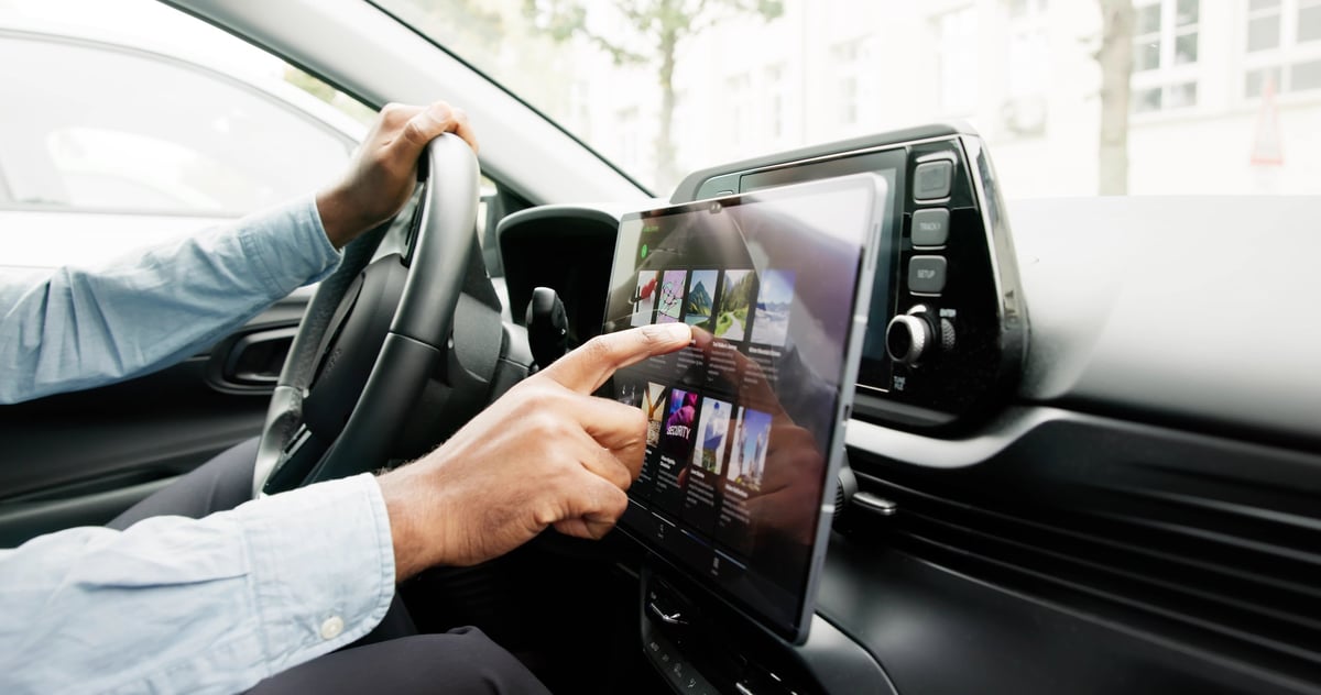 Driver at the wheel of a modern vehicle with a touchscreen display